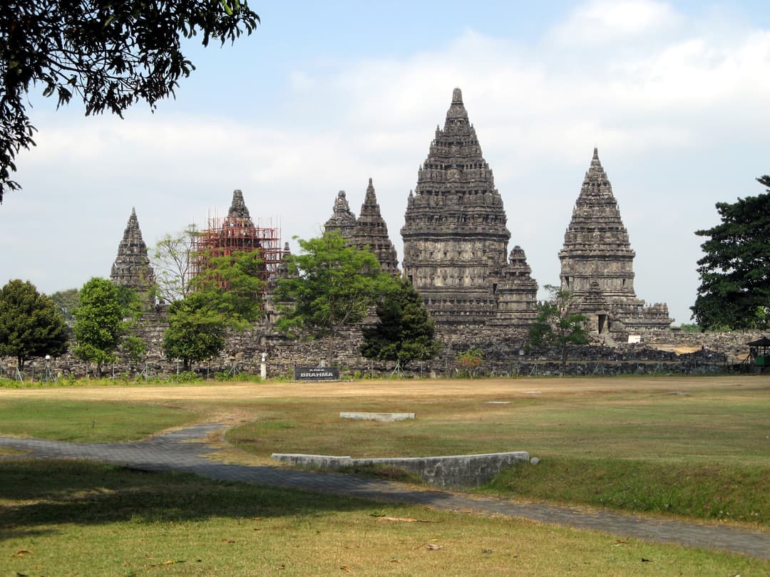 Prambanan temples from grounds, one under restoration.
