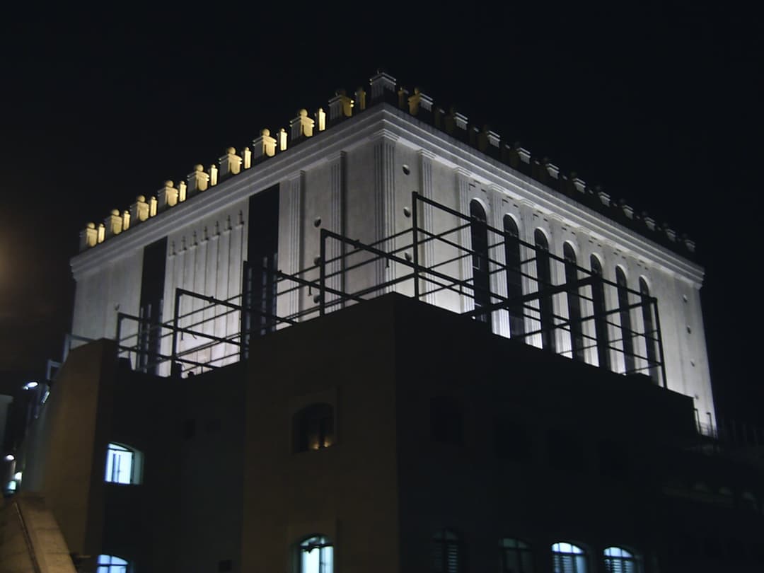 Belz Great Synagogue at night, low angle.