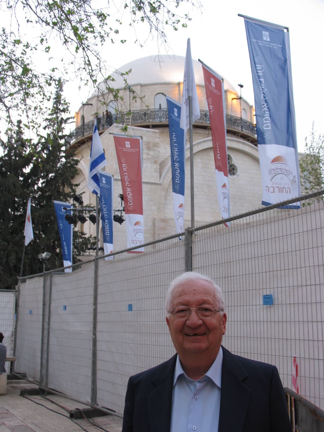 The synagogue's grand dome, adorned with golden stars, dominates the Jerusalem skyline.