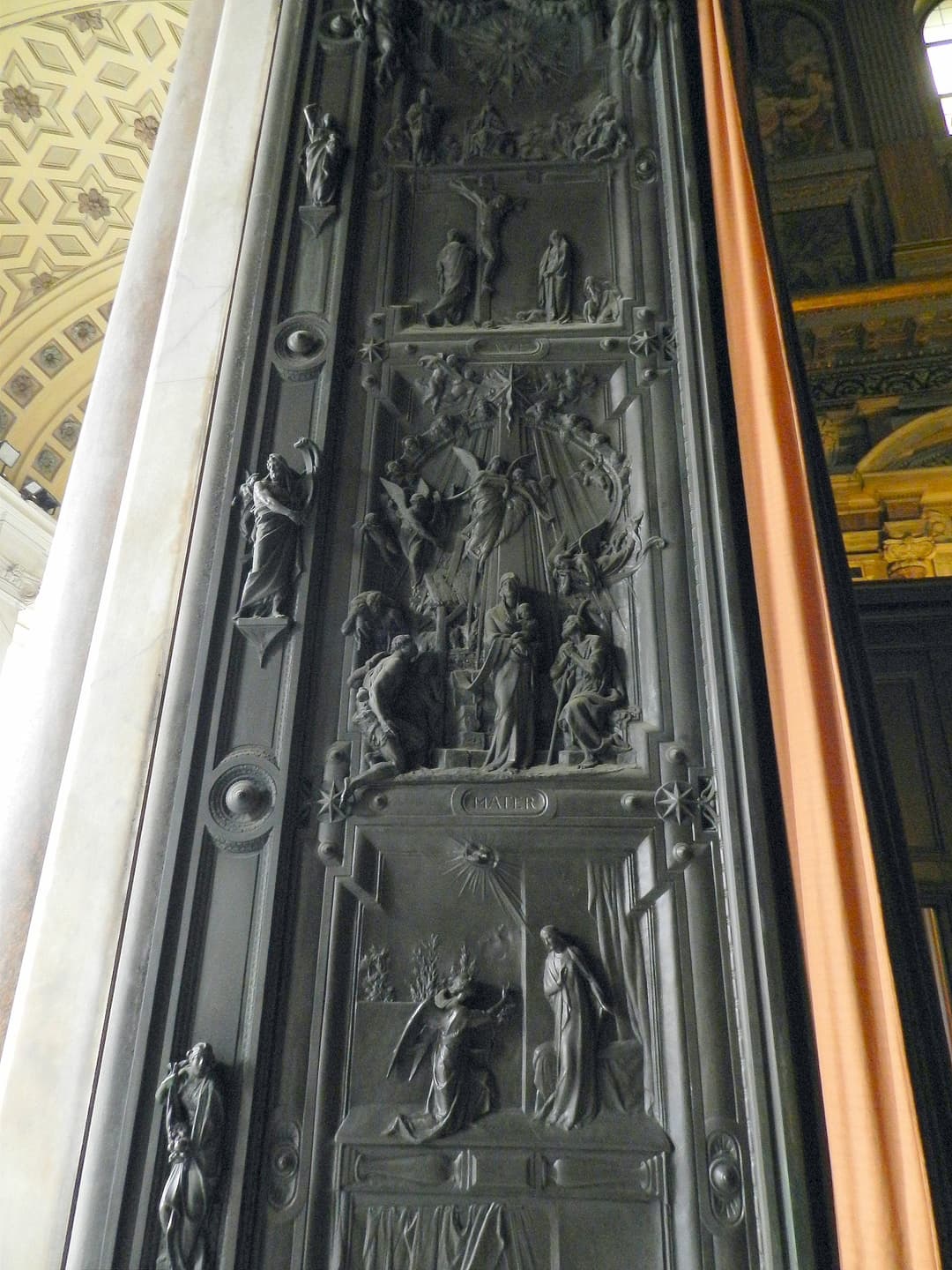 Detail of the intricate bronze door relief panel at Santa Maria Maggiore.