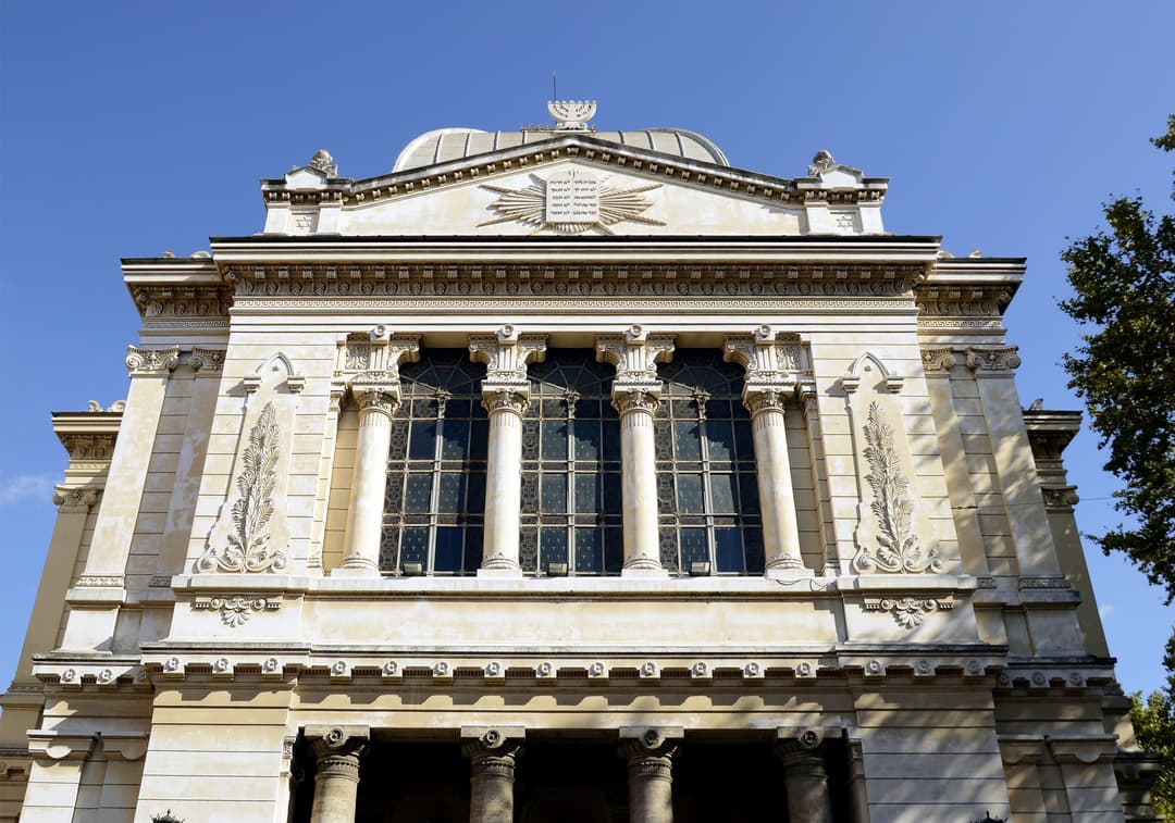 Low-angle view of the Great Synagogue of Rome's front facade.