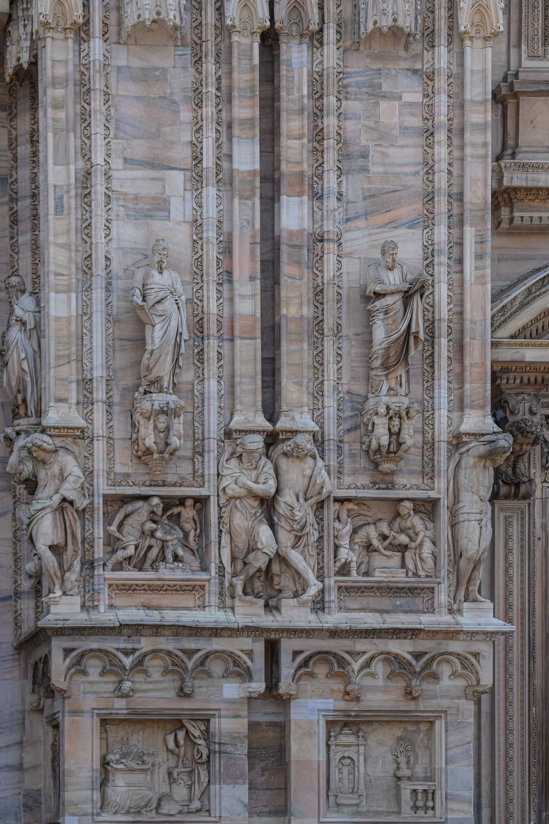 Marble reliefs and statues on the facade of Milan Cathedral