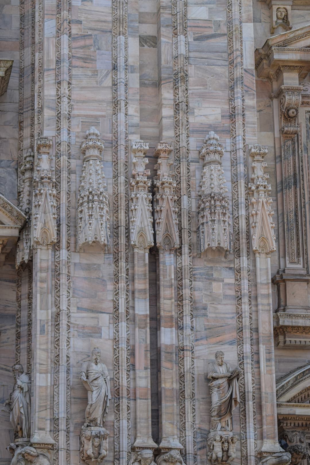 Detail of Gothic marble carvings and statues on the Milan Cathedral facade