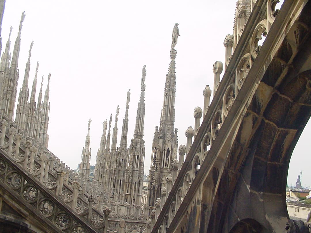 Marble spires and flying buttresses on the roof of Milan Cathedral