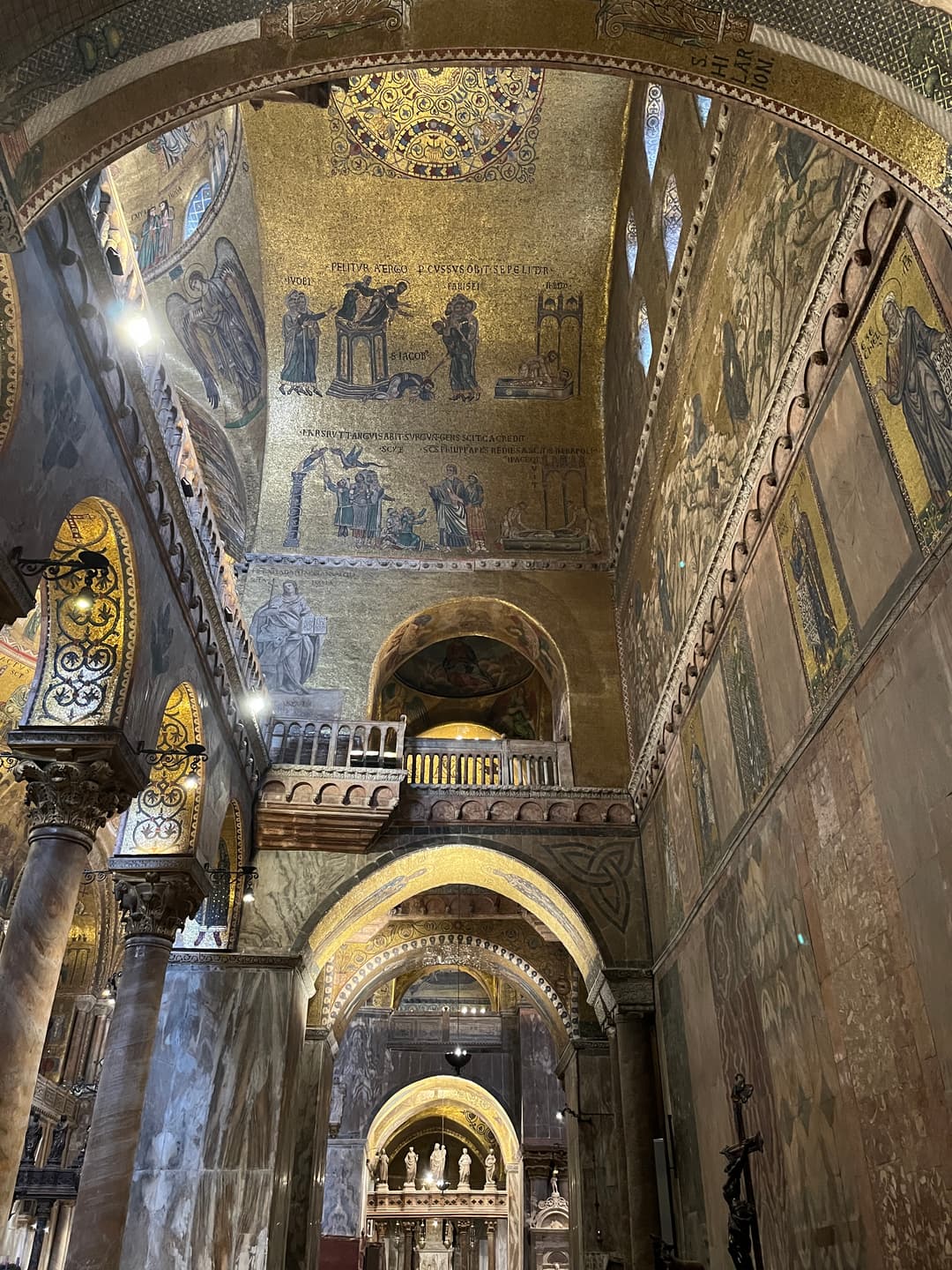 Interior view of vaulted arches and gold mosaics in St. Mark's Basilica