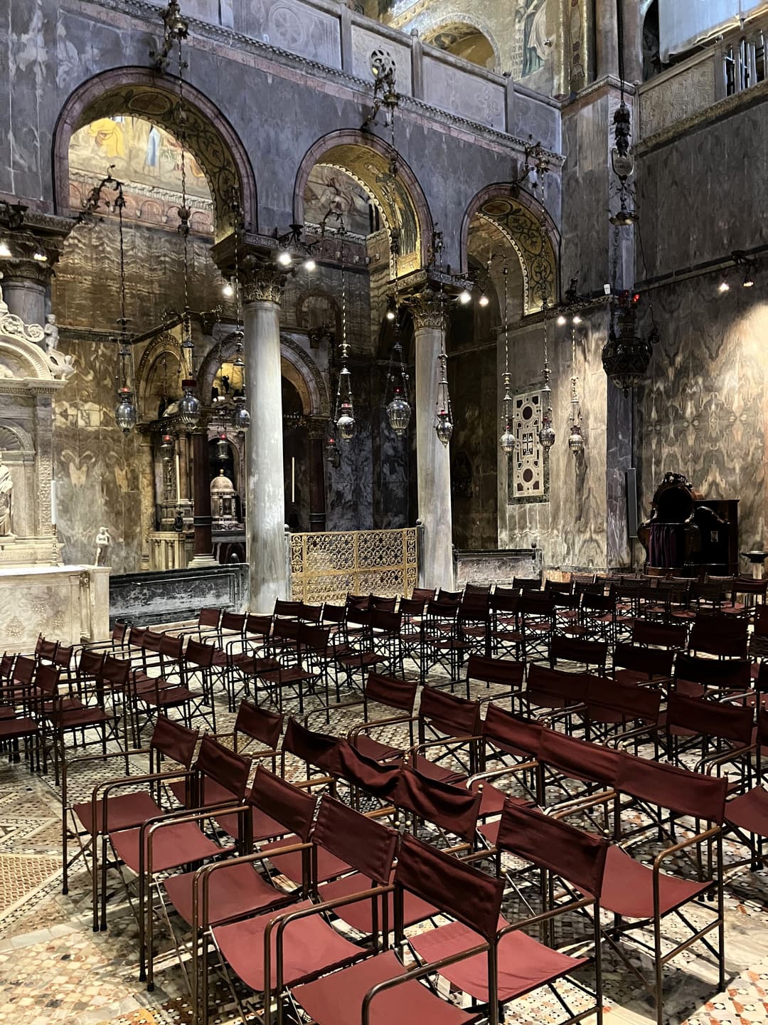 Interior view of marble columns, hanging lamps, and seating.