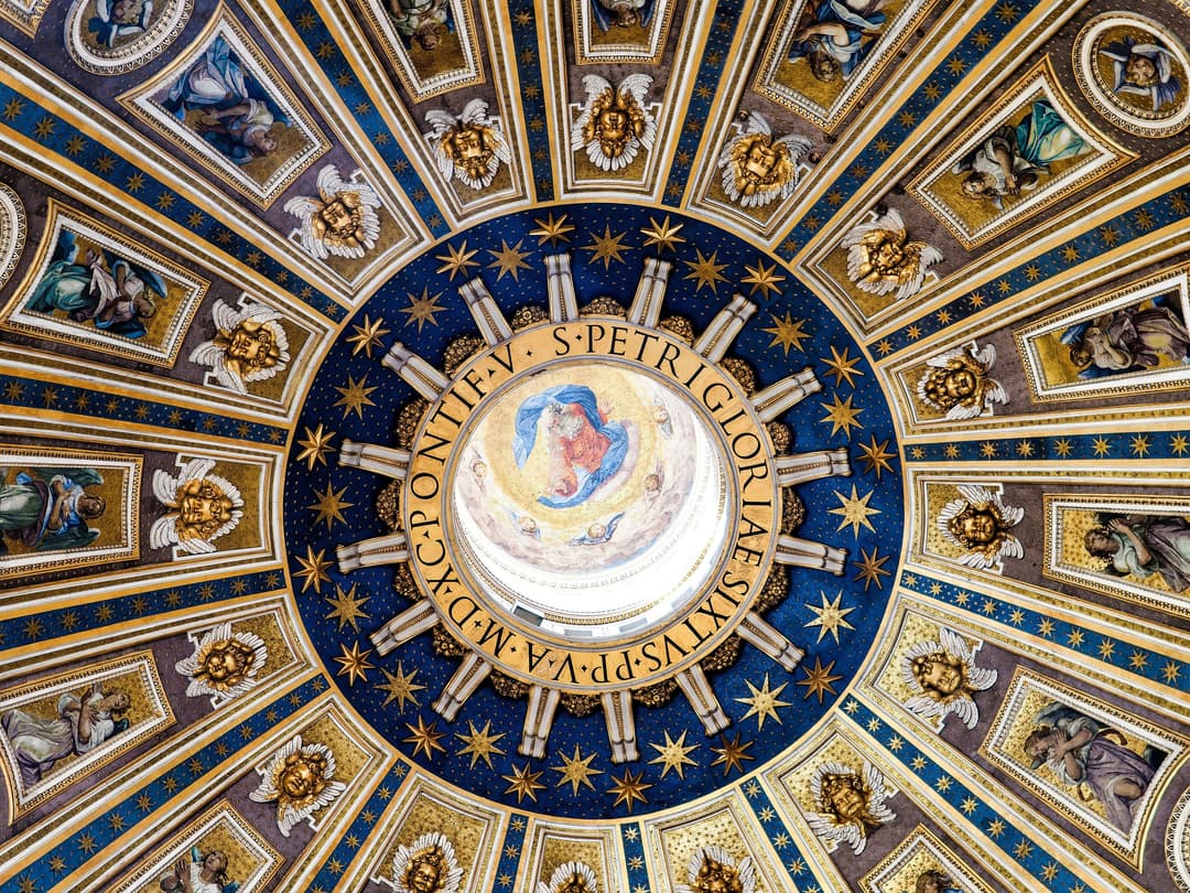 Interior view looking directly up at the mosaic dome of St. Peter's Basilica.