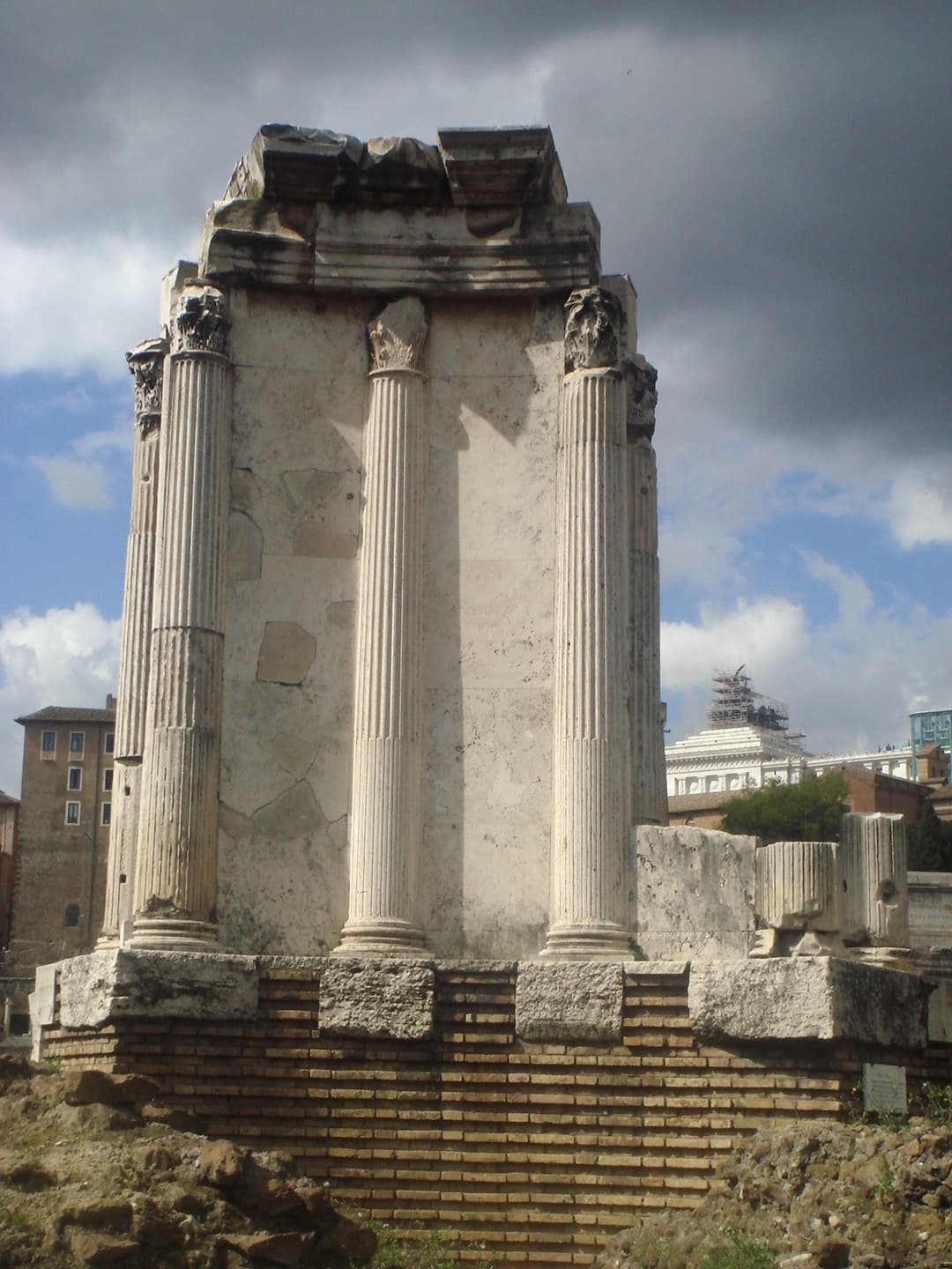 Remaining podium and Corinthian columns of the Temple of Vesta in daylight.