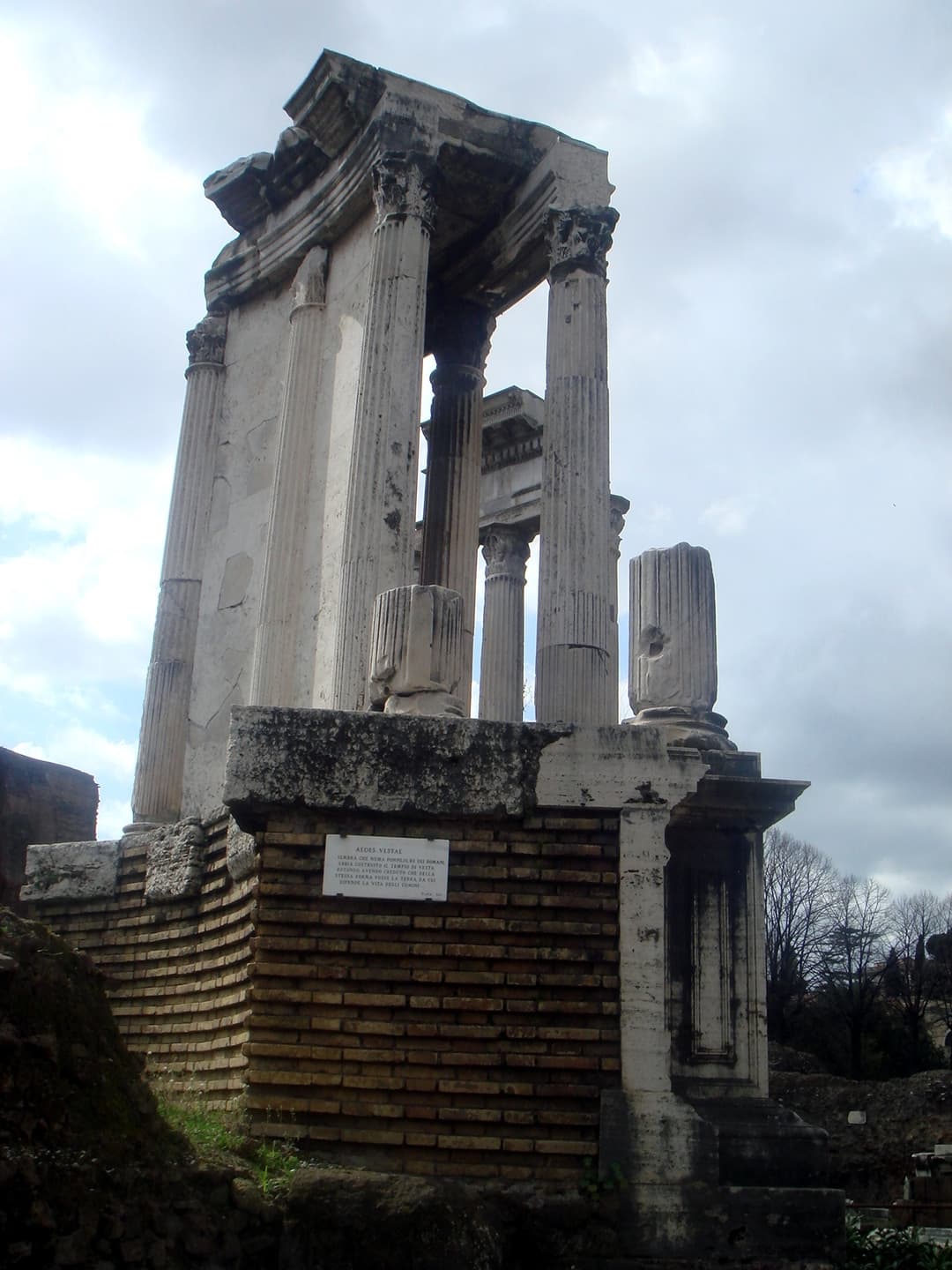 Low-angle view of the Temple of Vesta's podium and Corinthian colonnade.