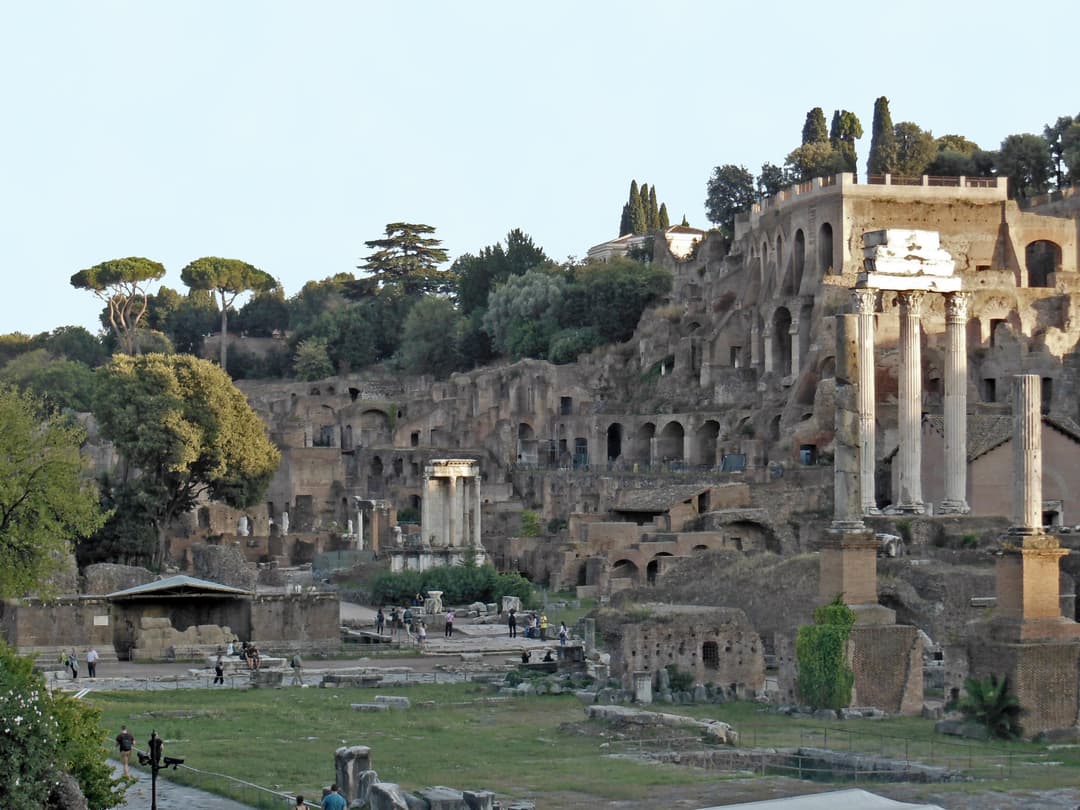 Wide exterior view of the Temple of Vesta and Palatine Hill ruins.