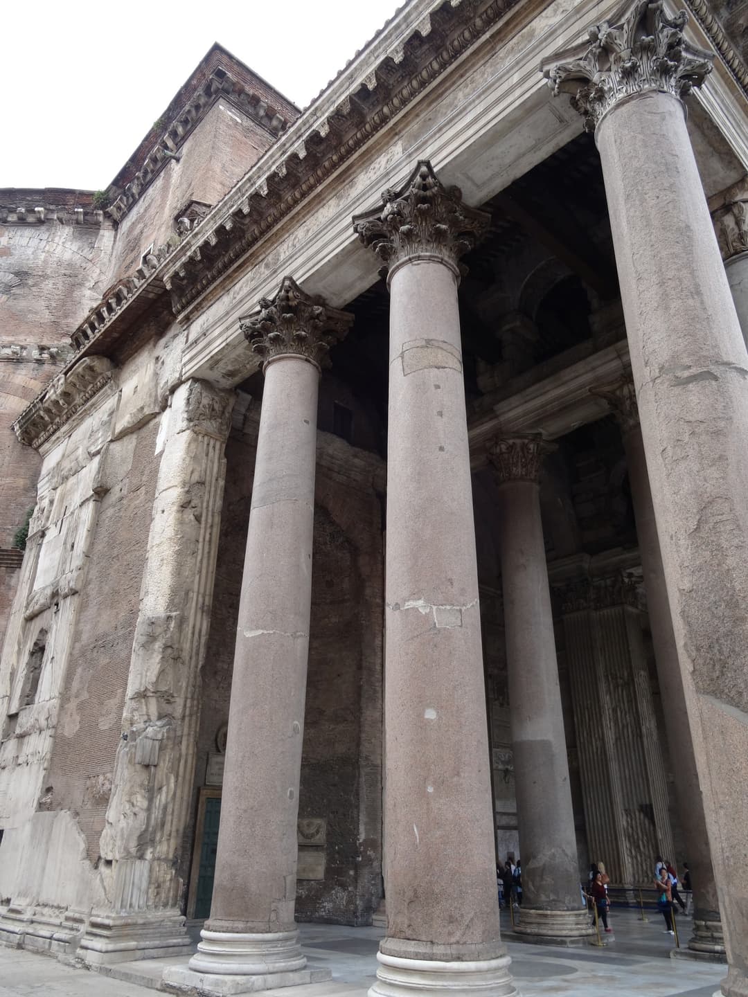 Low-angle view of the Corinthian columns of the Pantheon's portico.