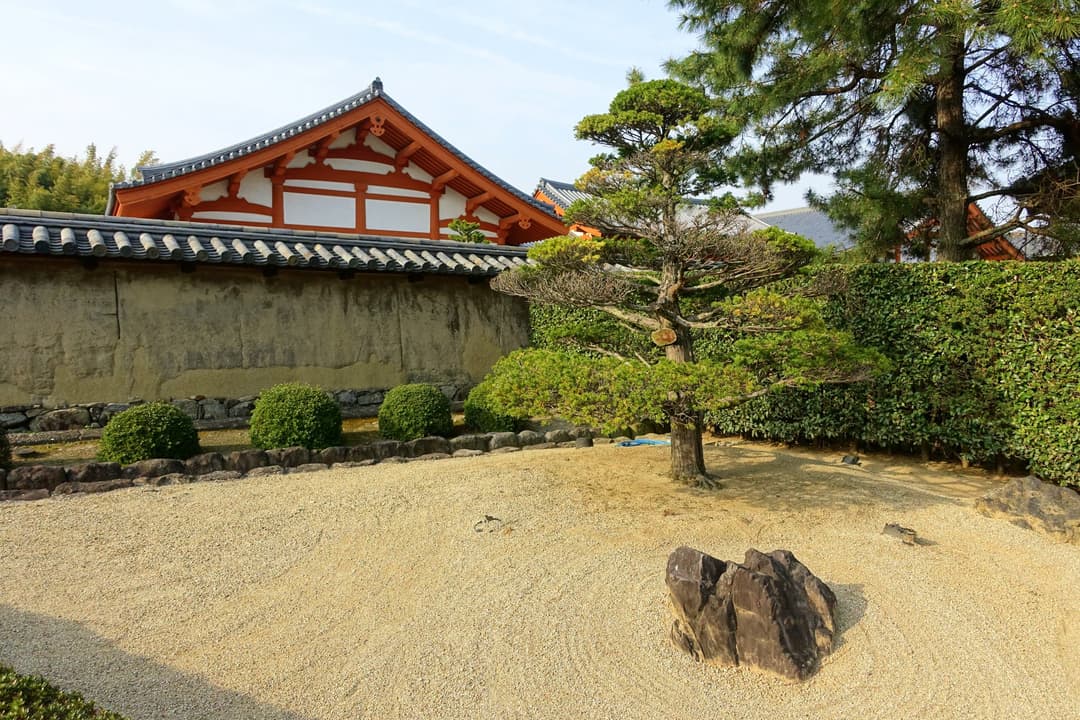 Raked gravel dry garden and pine tree on the grounds of Hōryū-ji.