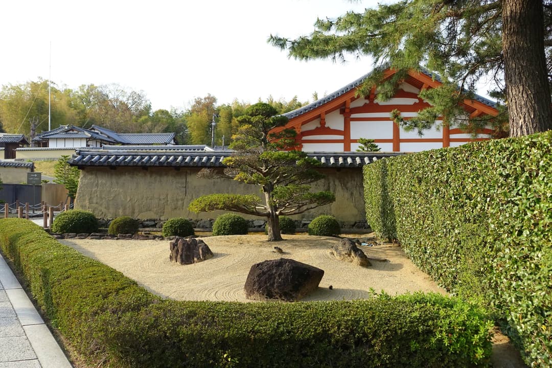 Raked rock garden and earthen wall on the grounds of Hōryū-ji.