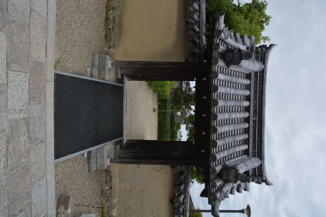 Traditional tiled gateway and earthen wall at Hōryū-ji