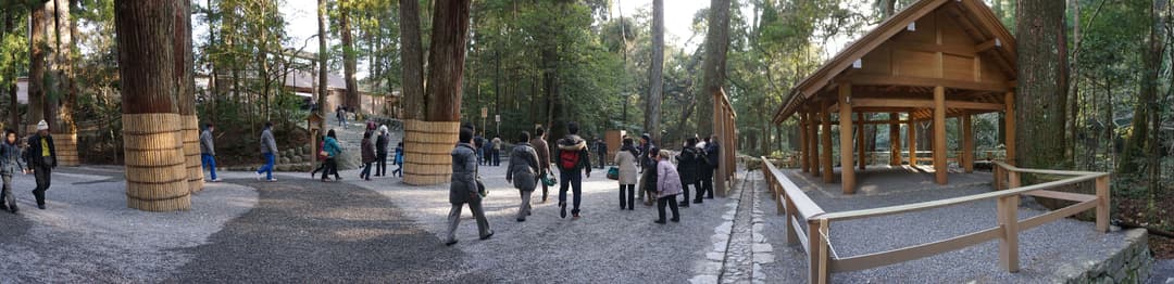 Panoramic view of visitors on the forested grounds of Ise Grand Shrine.
