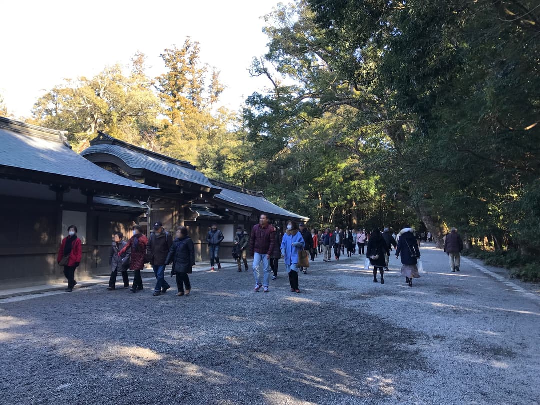Visitors walking along the gravel path of Ise Grand Shrine in daylight