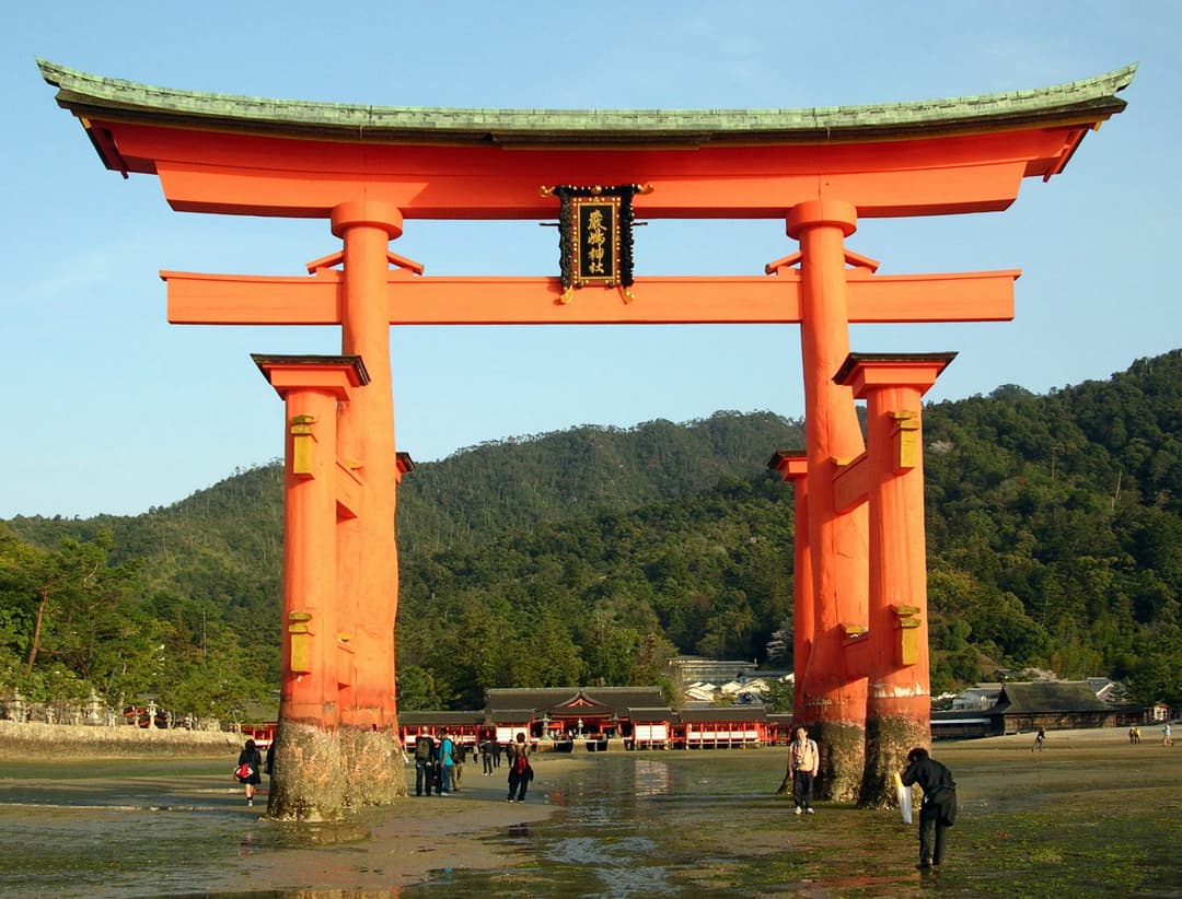 The O-torii gate of Itsukushima Shrine at low tide, afternoon view.