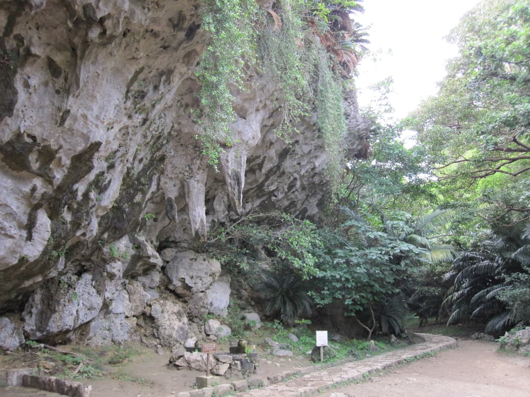 Limestone stalactite overhang and stone path at Sefa-Utaki.