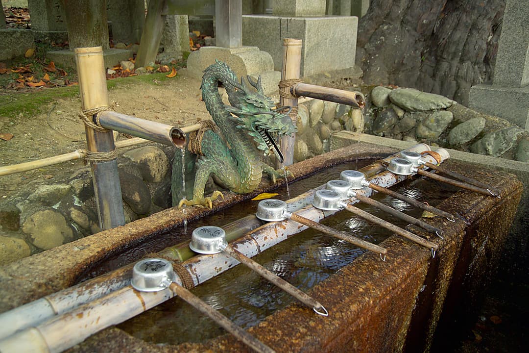 Bronze dragon spout and ladles at a temizuya water purification basin