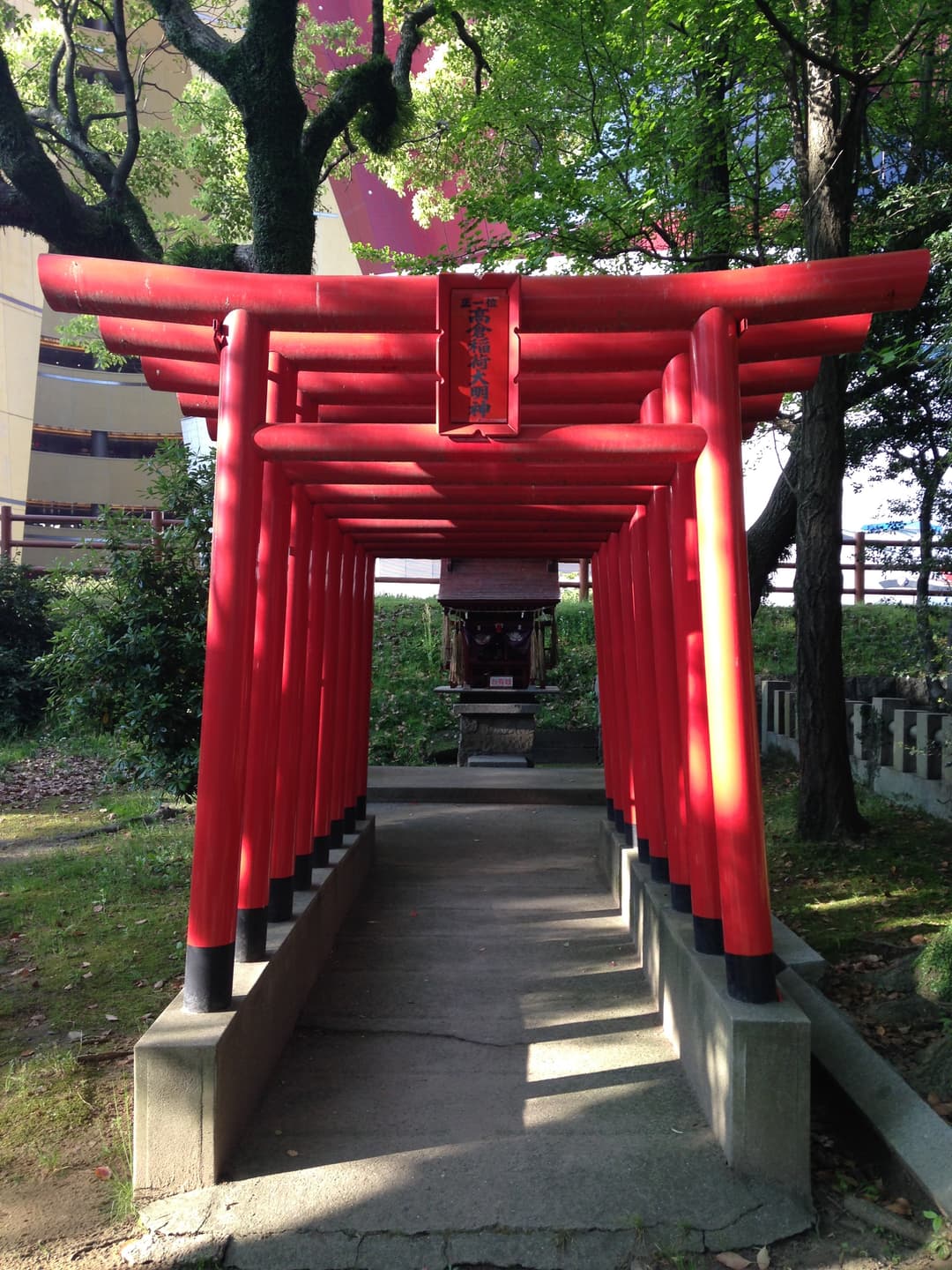 Red torii gate path leading to Takakura Inari sub-shrine