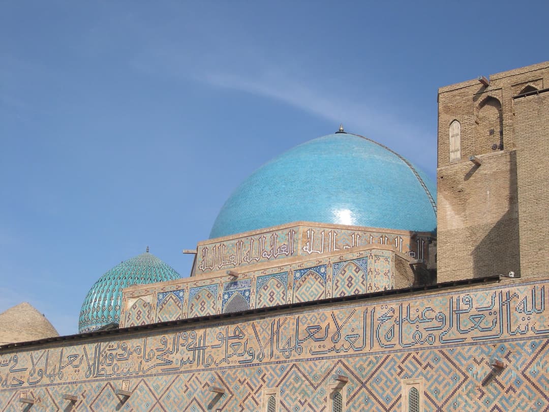 Detail of the turquoise tiled domes and calligraphic friezes.