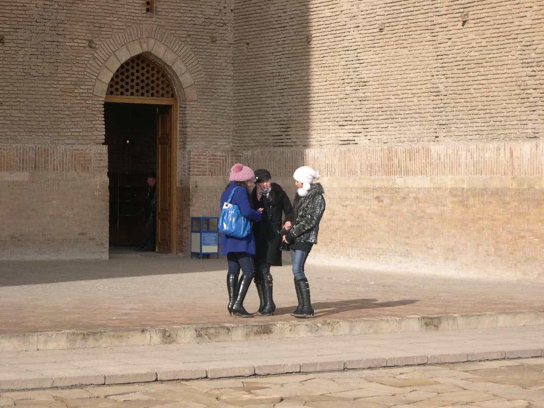 Visitors outside an arched entrance of the mausoleum