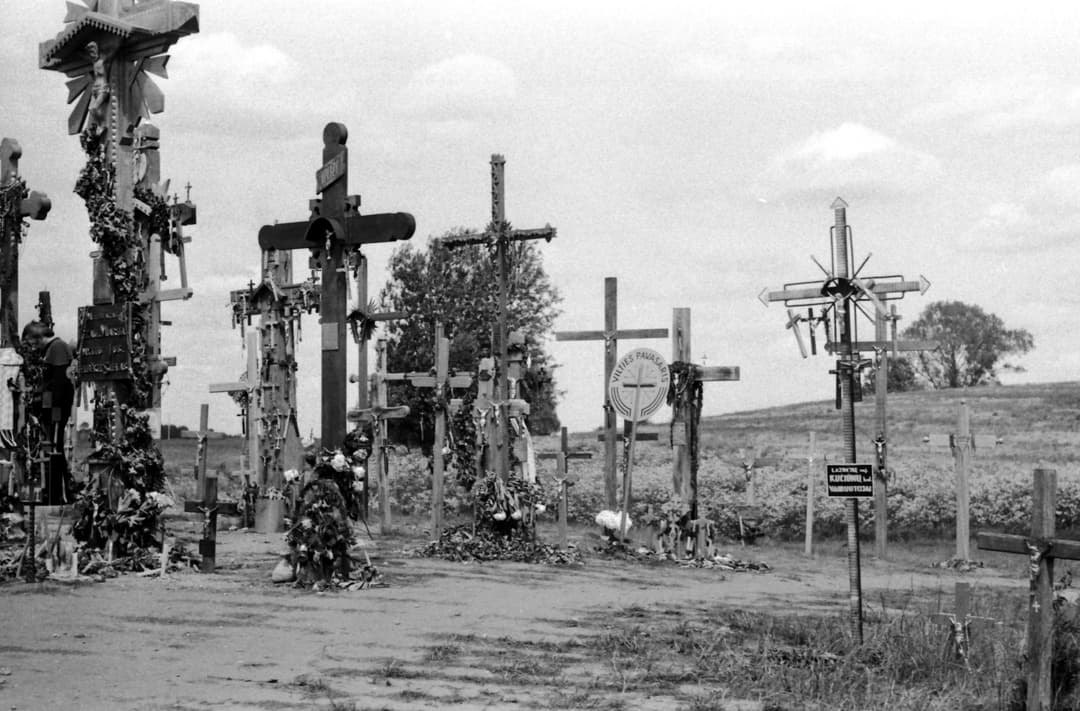 Ground-level view of carved wooden and metal crosses on the grounds.