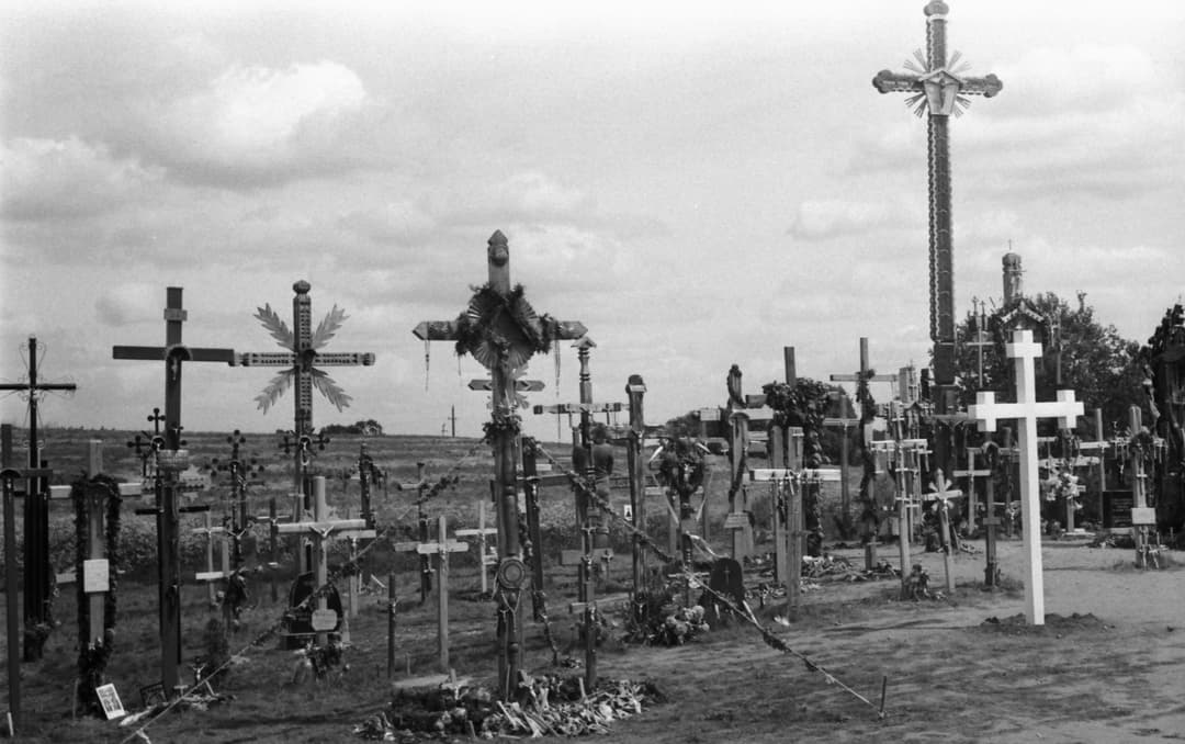 Exterior view of carved Baltic wooden and metal crosses across the grounds.