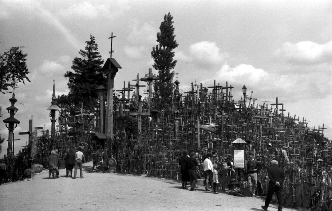 Visitors along the path at the base of the Hill of Crosses.