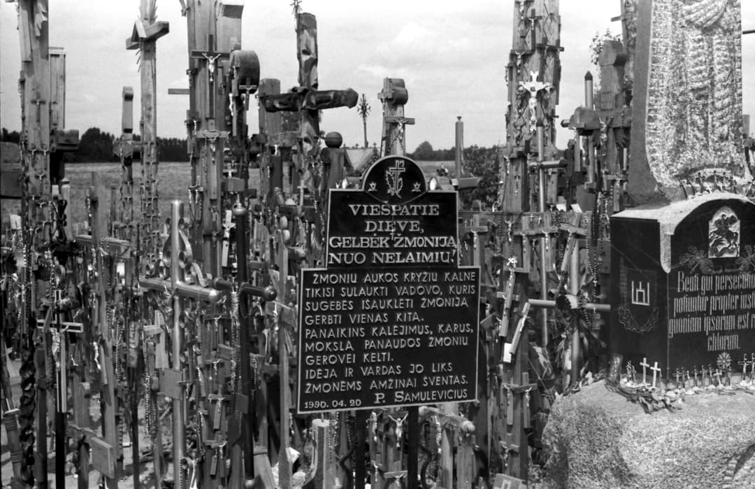 Inscribed memorial plaques amidst crosses at the Hill of Crosses.