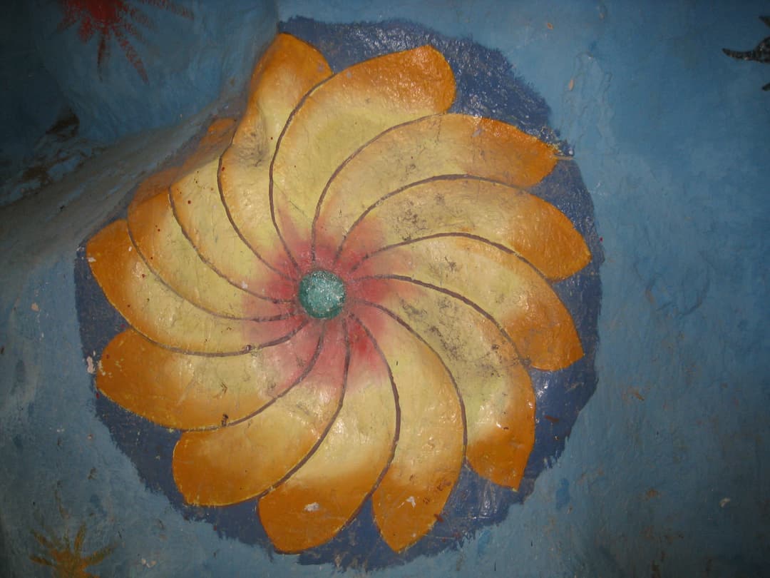 Painted floral relief detail on the interior cave wall.