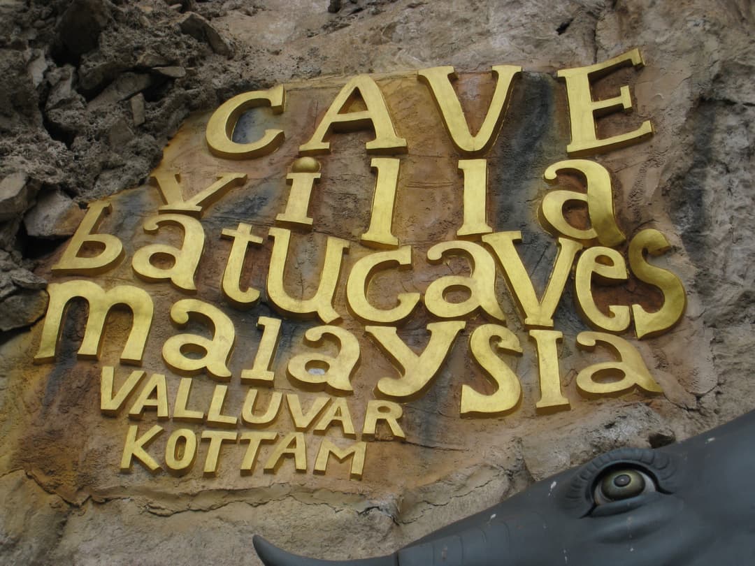 Golden sign for Cave Villa and Valluvar Kottam at Batu Caves