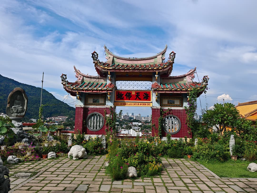 Decorative Chinese gateway and garden courtyard at Kek Lok Si Temple.
