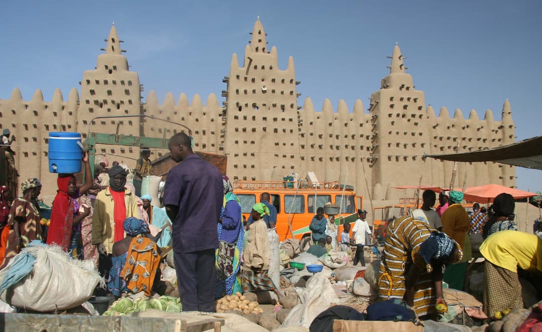 The Great Mosque of Djenné rising above the bustling market square.