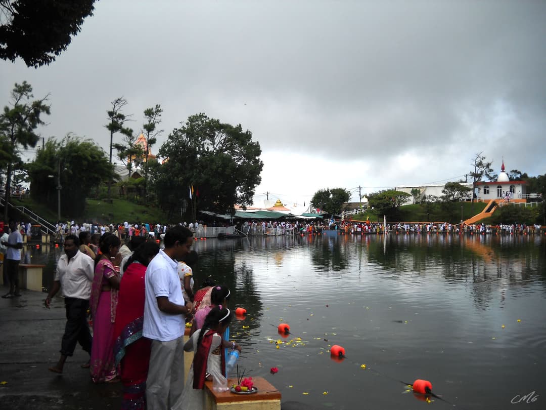 Devotees offering prayers along the shore of Ganga Talao