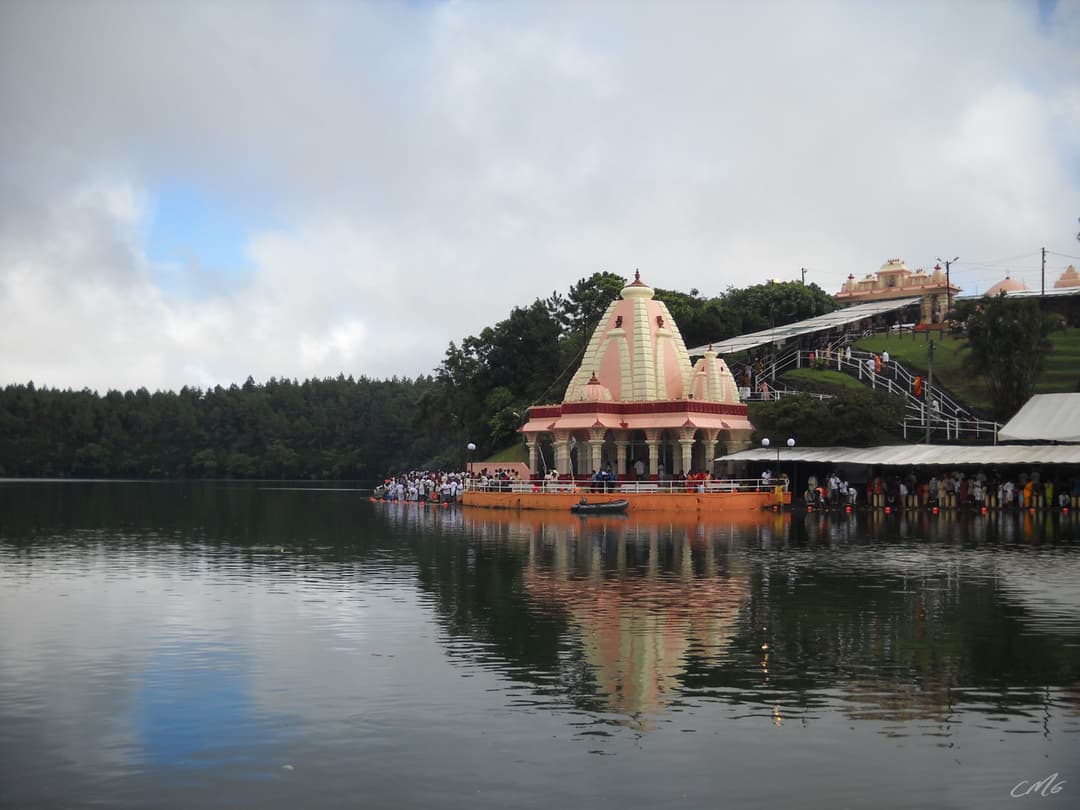 Lakeside temple pavilion and reflection across Ganga Talao.