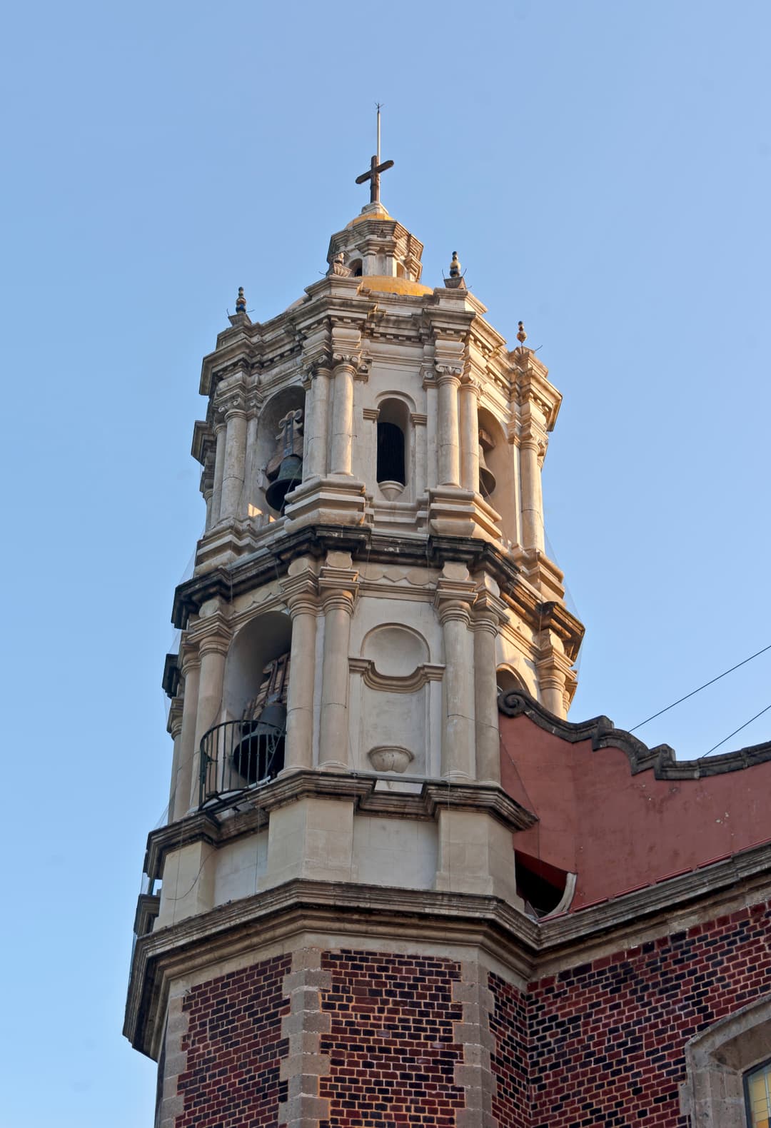 Low-angle view of the historic Baroque bell tower in late afternoon light.