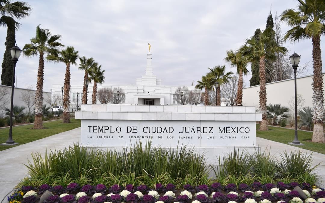 Front entrance sign and spire of Ciudad Juárez Mexico Temple, daytime.