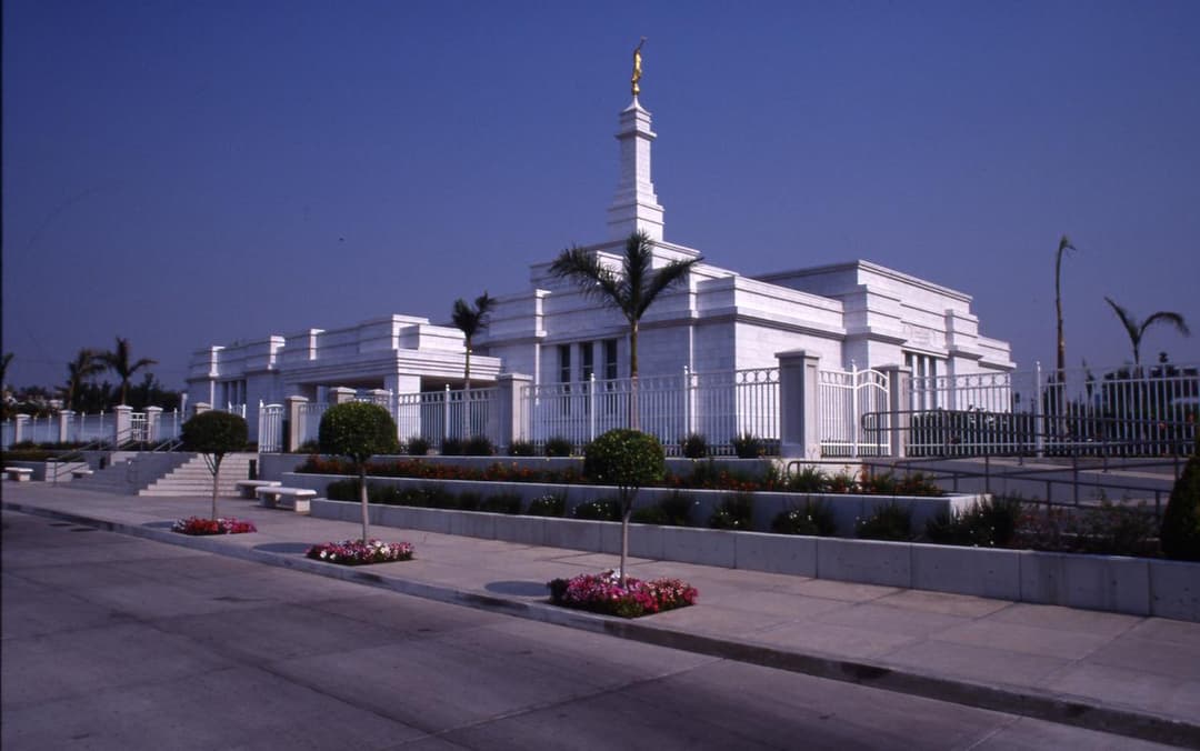 Front and side view of Guadalajara Mexico Temple with spire and gardens.