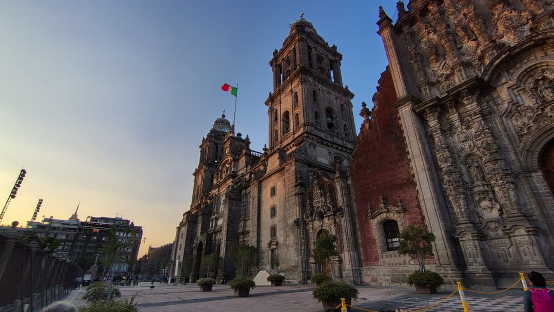 Low-angle view of the Mexico City Metropolitan Cathedral at twilight.