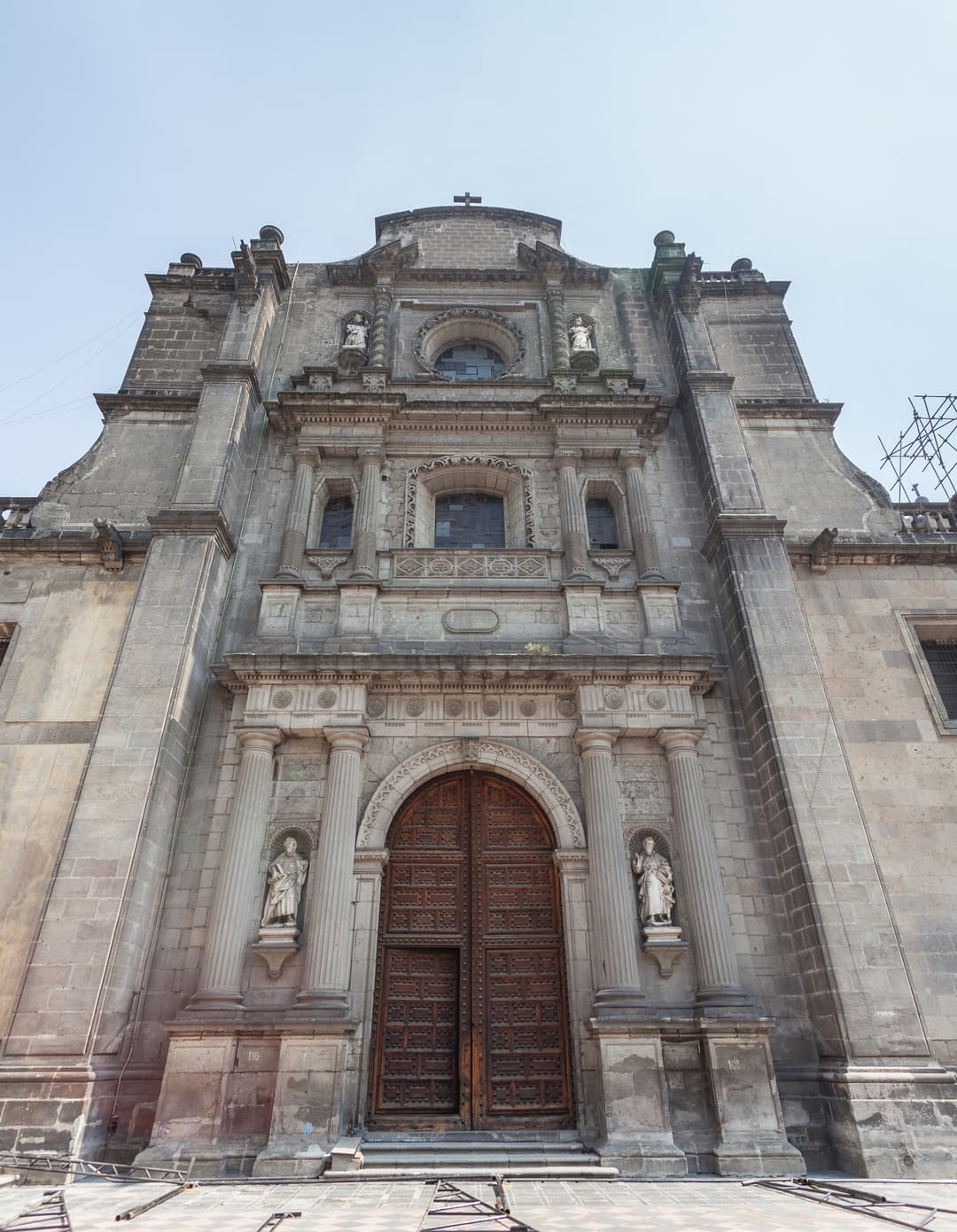 Low-angle front view of the carved stone facade and arched entrance portal.