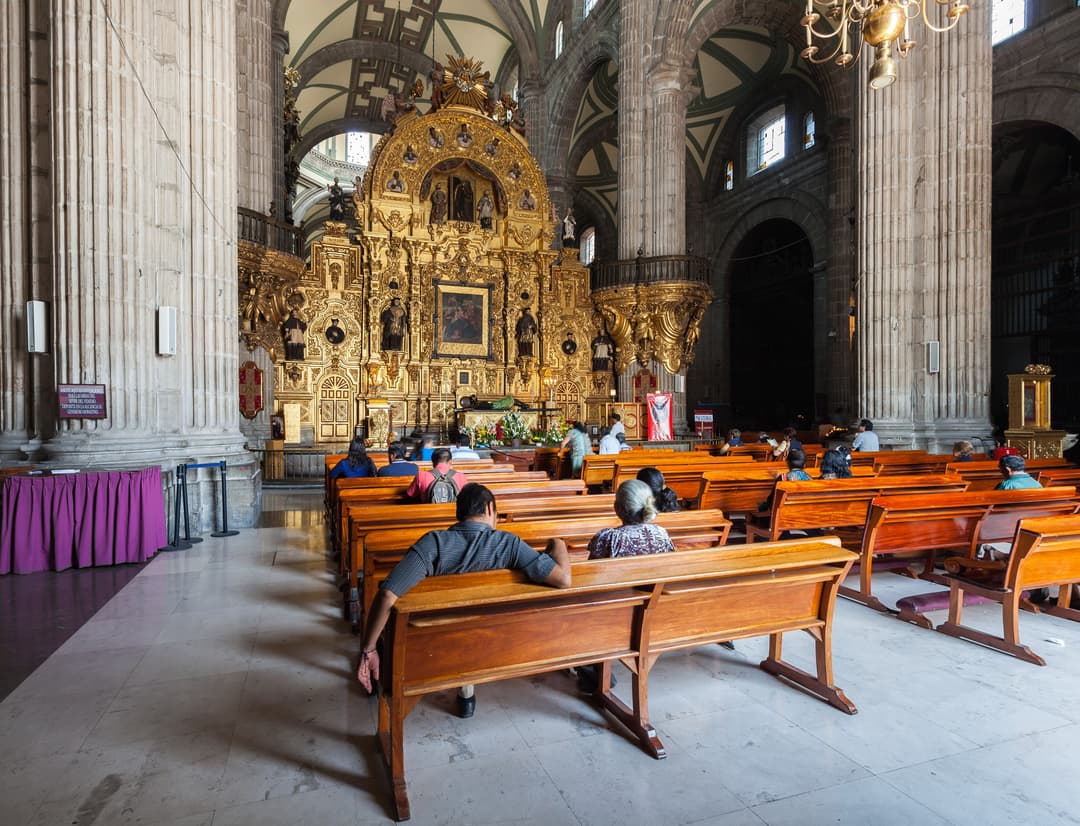 Interior view showing pews and the ornate golden Altar of the Lord of Poison.