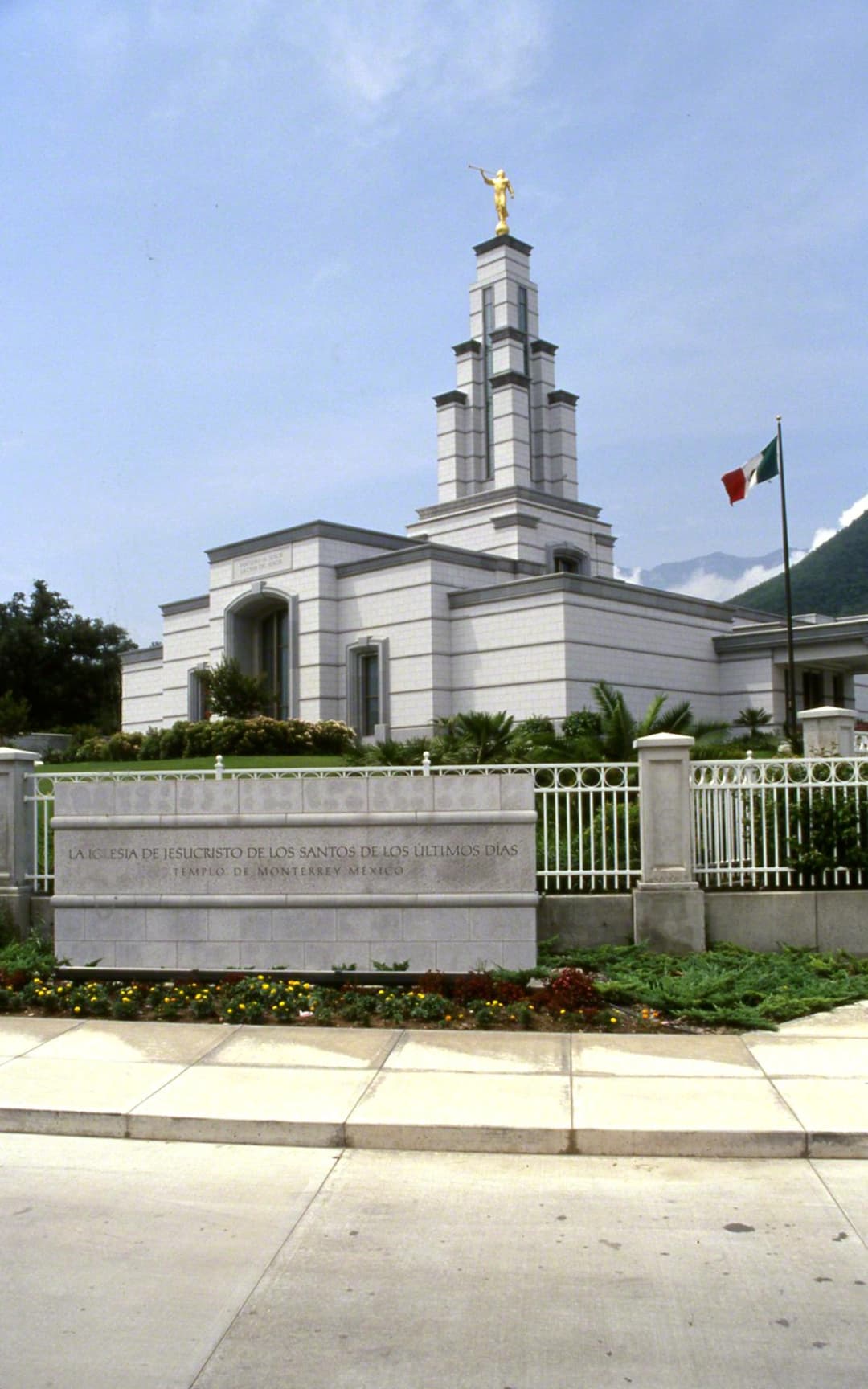 Monterrey Mexico Temple exterior, Angel Moroni, Mexican flag, and sign.