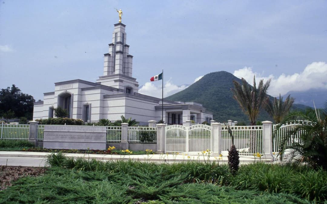 Monterrey Mexico Temple, Angel Moroni, Mexican flag, and mountain backdrop.