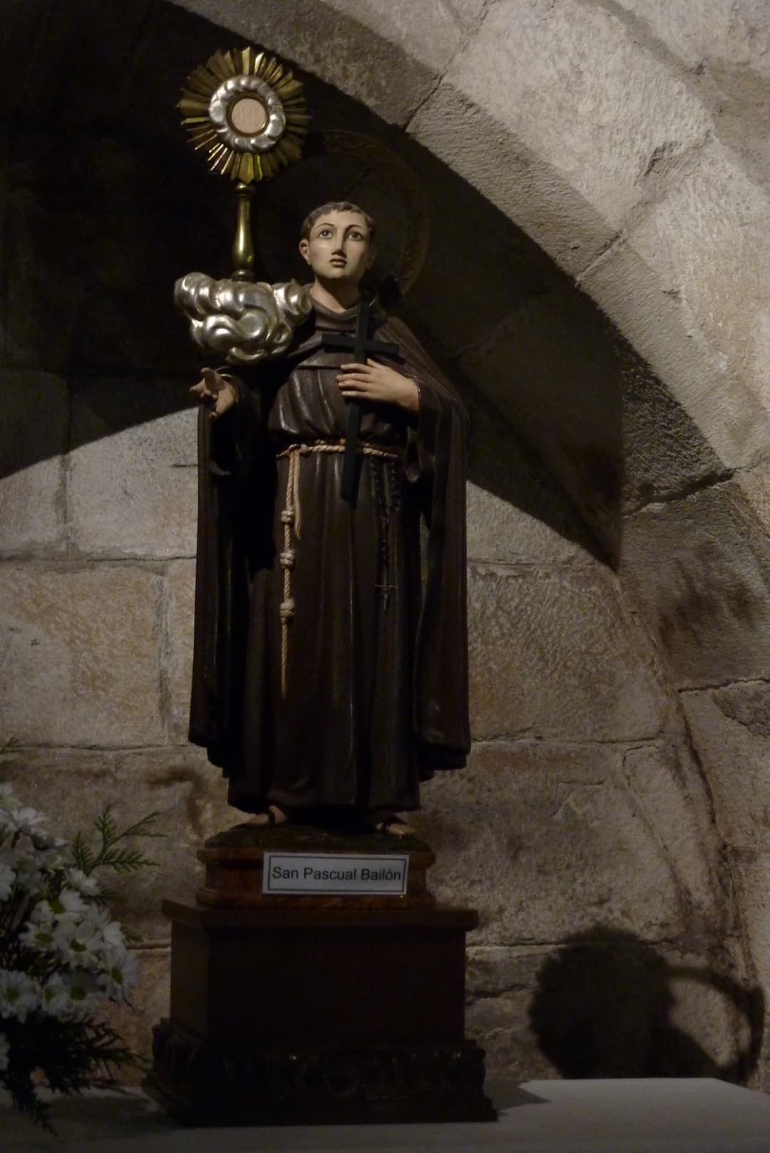 Interior statue of San Pascual Bailón in a stone niche.