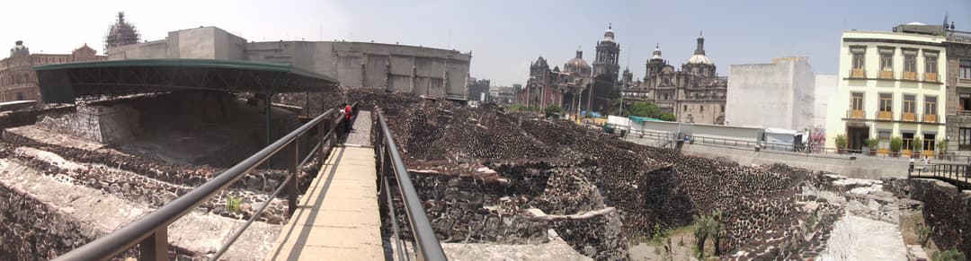Panoramic view of Templo Mayor archaeological site and cathedral towers.