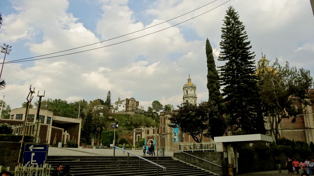 Wide view of Cerro del Tepeyac and Baptistery from Plaza de las Américas.