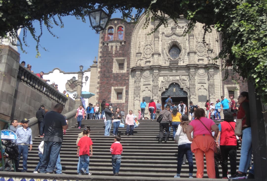 Low-angle view of the grand staircase and facade of Capilla del Cerrito.