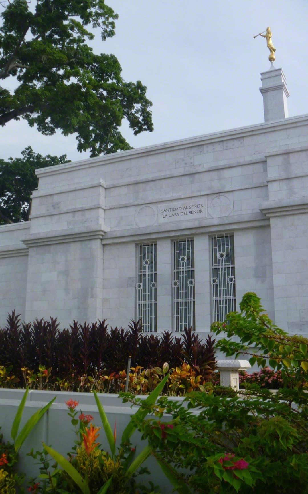 Low-angle view of the Villahermosa Mexico Temple facade, spire, and gardens.