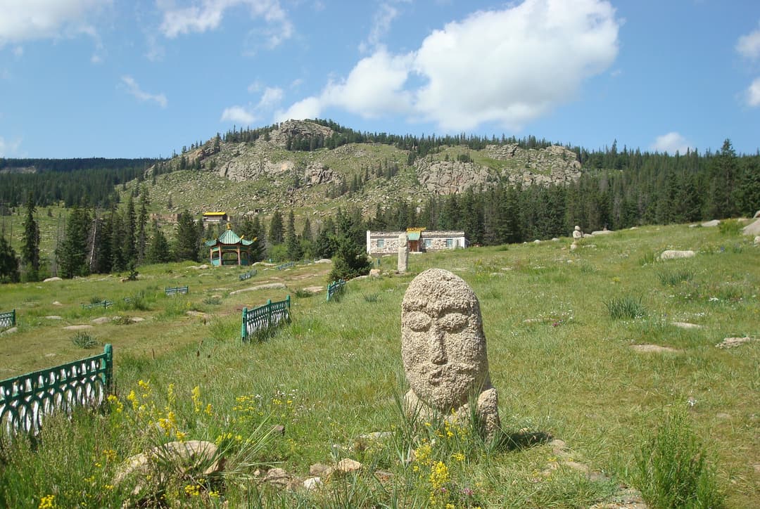Carved stone head on the grounds of Manzushir Monastery
